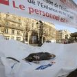 Paris rat-catchers display one of their prey at a protest outside city hall to demand more staff and payment of bonuses