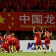 Chinese players celebrate after Yu Dabao scores during their World Cup football qualifying match against South Korea in Changsha, China on March 23, 2017