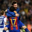 Barcelona's Paco Alcacer (bottom) celebrates with teammate Lionel Messi during their match against Real Sociedad at the Camp Nou stadium in Barcelona on April 15, 2017