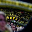 Fans hold up a scarfs during the UEFA Champions League 1st leg quarter-final football match Borussia Dortmund vs. Monaco in Dortmund, western Germany on April 12, 2017