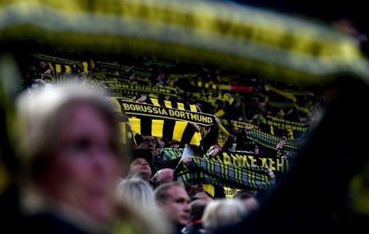 Fans hold up a scarfs during the UEFA Champions League 1st leg quarter-final football match Borussia Dortmund vs. Monaco in Dortmund, western Germany on April 12, 2017