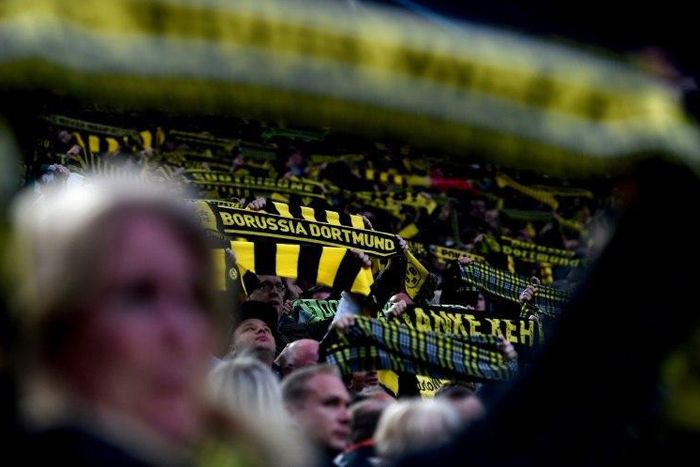 Fans hold up a scarfs during the UEFA Champions League 1st leg quarter-final football match Borussia Dortmund vs. Monaco in Dortmund, western Germany on April 12, 2017