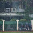 Policemen check the back garden of an upscale cafe in Dhaka on July 3, 2016 a day after a bloody siege ended with the death of 22 hostages, including 18 foreigners