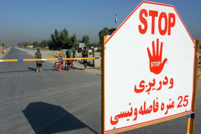Afghan security personnel stand at a checkpoint outside Jalalabad Airport