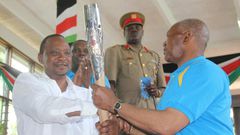 President Uhuru Kenyatta receiving the Queen's Baton Relay symbol