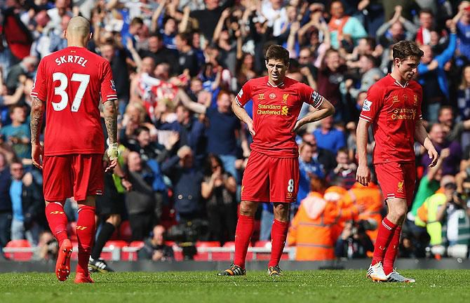 Liverpool players after defeat to Chelsea cost them the title