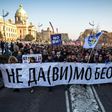 Protesters walk past the Serbian National Assembly building during an anti-government protest in Belgrade on February 15, 2017