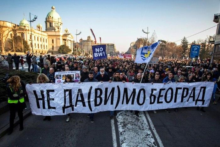 Protesters walk past the Serbian National Assembly building during an anti-government protest in Belgrade on February 15, 2017