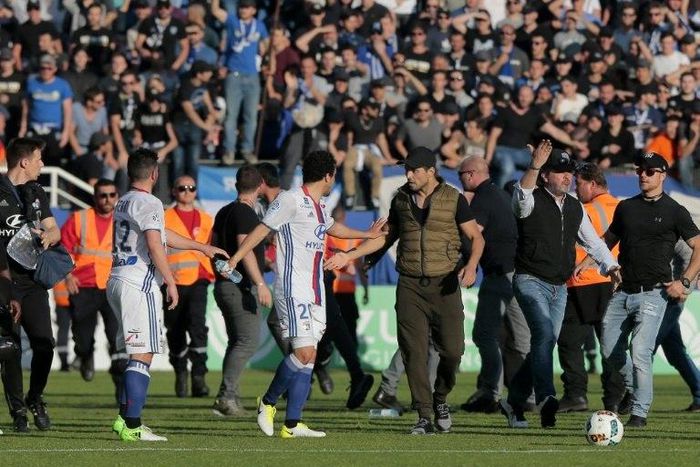 A Bastia's official (C-R) argues with Lyon's Brazilian defender Rafael da Silva (C-L) during scuffles at half-time between some of Lyon's players and Bastia's officials, during the French L1 football match Bastia vs Lyon on April 16, 2017