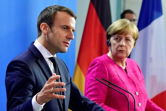 German Chancellor Angela Merkel and French President Emmanuel Macron say they are ready to change EU treaties if necessary