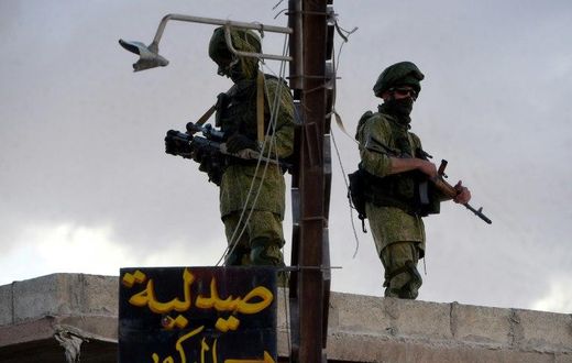 Russian soldiers patrol in a small Syrian village near the city of Hama on May 4, 2016
