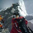 Mountaineers walk past the Hillary Step while pushing for the summit of Mount Everest