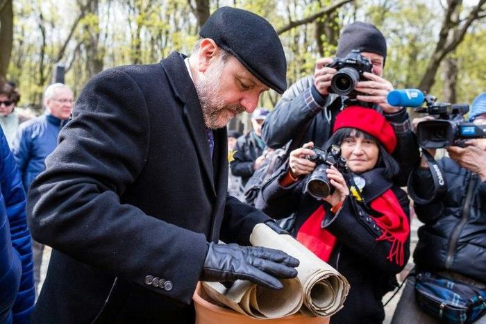 Polish Chief Rabbi Michael Schudrich prepares broken Torah scrolls for a burial ceremony in Warsaw
