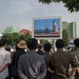 People watch a screen showing coverage of the Pukguksong-2 missile launch, in central Pyongyang on May 22, 2017