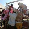Yemenis recover the bodies of people at a detention centre hit by Saudi-led coalition air strikes in Hodeidah, on October 30, 2016