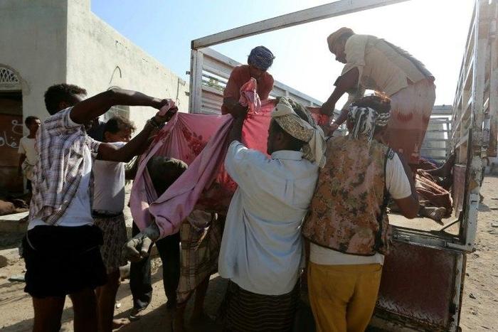 Yemenis recover the bodies of people at a detention centre hit by Saudi-led coalition air strikes in Hodeidah, on October 30, 2016