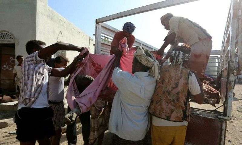 Yemenis recover the bodies of people at a detention centre hit by Saudi-led coalition air strikes in Hodeidah, on October 30, 2016