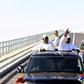 Senegal's president Macky Sall (L) and Gambian President Adama Barrow (R) wave as they inaugurate the Senegambia Bridge built to facilitate trade and travel in this part of West Africa