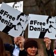 People hold placards with hashtag #FREEDENIZ to protest the detantion of German journalist Deniz Yucel in front of Turkish embassy in Berlin on February 28, 2017