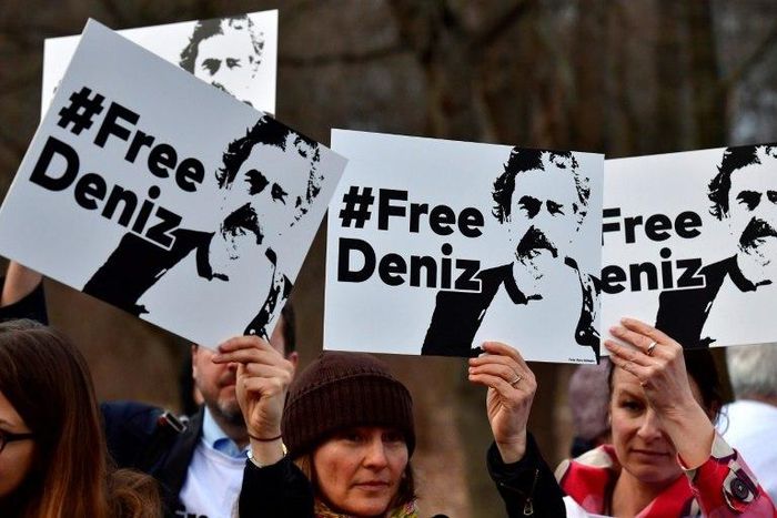 People hold placards with hashtag #FREEDENIZ to protest the detantion of German journalist Deniz Yucel in front of Turkish embassy in Berlin on February 28, 2017