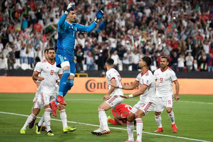 Iran goalkeeper Alireza Beiranvand celebrates after saving an Oman penalty