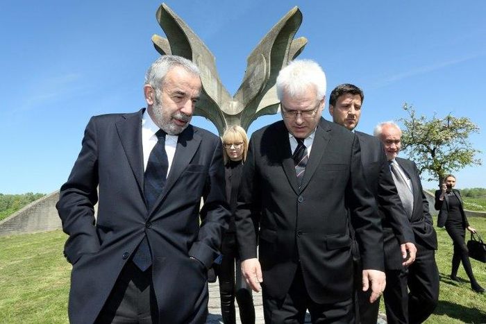 Coordinator of the Jewish communities in Croatia Ognjen Kraus (L) and Croatian rabbi of the Jewish community Luciano Mose Prelevic (R) walk in front of a memorial in the shape of a flower in Jasenovac on April 15, 2016