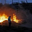 Jewish settlers set tyres ablaze at the Amona outpost, northeast of Ramallah, on February 1, 2017