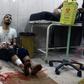 A wounded man sits on the floor in a crowded makeshift hospital in eastern Aleppo as regime aircraft and artillery pounded neighbourhoods in the rebel-held sector of Syria's second city on November 18, 2016