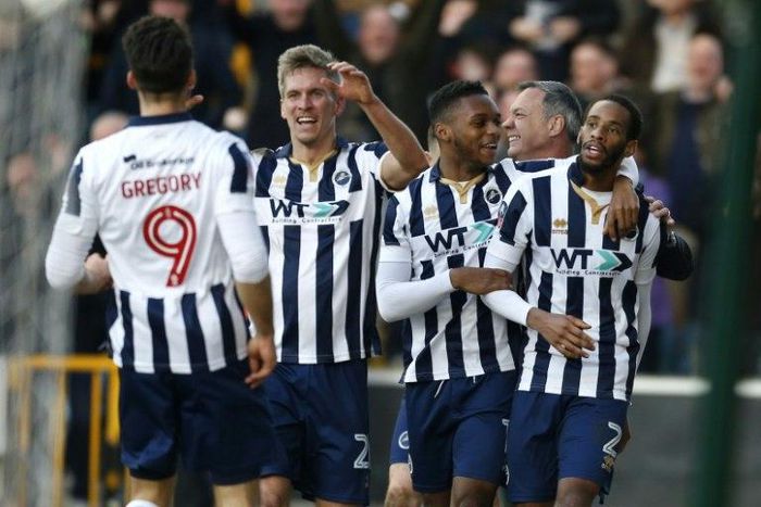 Millwall's Shaun Cummings (R) celebrates with teammates after scoring their only goal against Leicester City at The Den in south London on February 18, 2017