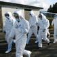 Wearing anti-virus suits, soldiers of Japan's Ground Self Defense Force head to a chicken farm in Sekikawa, Niigata prefecture, on November 29, 2016