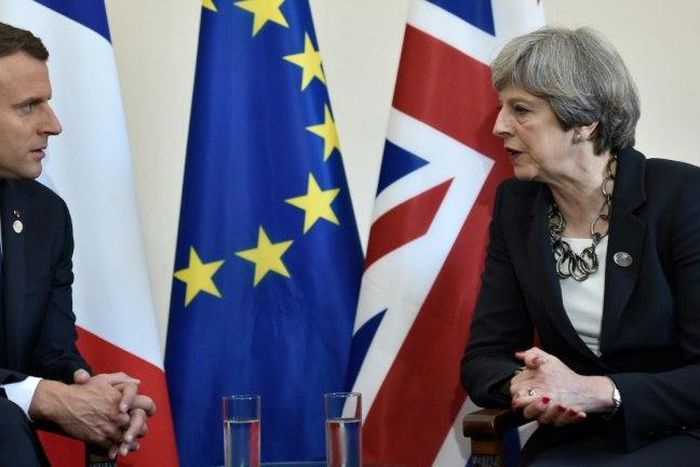 Britain's Prime Minister Theresa May (right) and French President Emmanuel Macron meet at the G7 summit in Taormina, Italy, on May 26, 2017