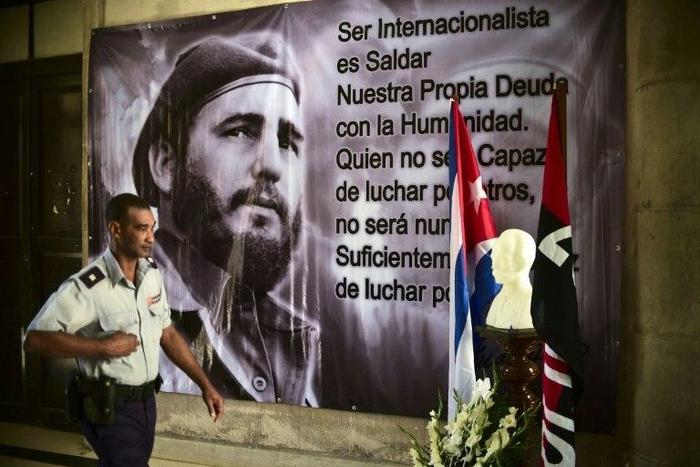 A police officer passes by a large portrait of late Cuban revolutionary leader Fidel Castro at the City Hall of the Guanabacoa municipality in Havana, on November 28, 2016