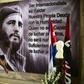A police officer passes by a large portrait of late Cuban revolutionary leader Fidel Castro at the City Hall of the Guanabacoa municipality in Havana, on November 28, 2016