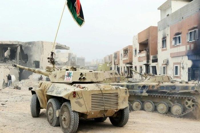 Infantry fighting vehicles belonging to forces loyal to Libya's Government of National Accord take position in Sirte's Al-Giza Al-Bahriya district on November 21, 2016