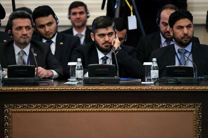 Chief opposition negotiator Mohammad Alloush (C) of the Jaish al-Islam (Army of Islam) rebel group attends the first session of Syria peace talks at Astana's Rixos President Hotel on January 23, 2017