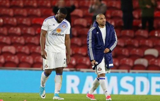 Sunderland's striker Victor Anichebe (L) and Sunderland's midfielder Wahbi Khazri walk from the picth after the English Premier League football match against Middlesbrough April 26, 2017