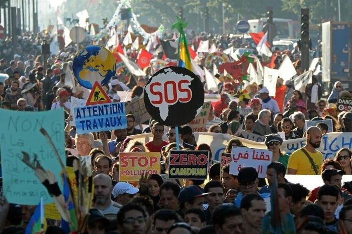 Demonstrators shout slogans and hold placards during a demonstration against climate change and calling for environmental action to protect the planet during a protest in Marrakesh on the sidelines of the COP22 climate conference on November 13, 2016