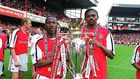 Lauren (left) and Kanu lift the English Premiership Trophy. Arsenal trained-coaching staff will be joined by Lauren as they help talent identification skills among Kenyan coaches as the country targets participation in the World Cup 2022 to be held in ...