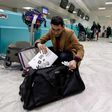 A Libyan traveller packs his laptop in his suitcase before boarding his flight for London at Tunis-Carthage International Airport on March 25, 2017