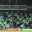 Celtic fans hold up team flags in the stands during the UEFA Champions League group stage football match between Celtic and Barcelona at Celtic Park in Glasgow on November 23, 2016