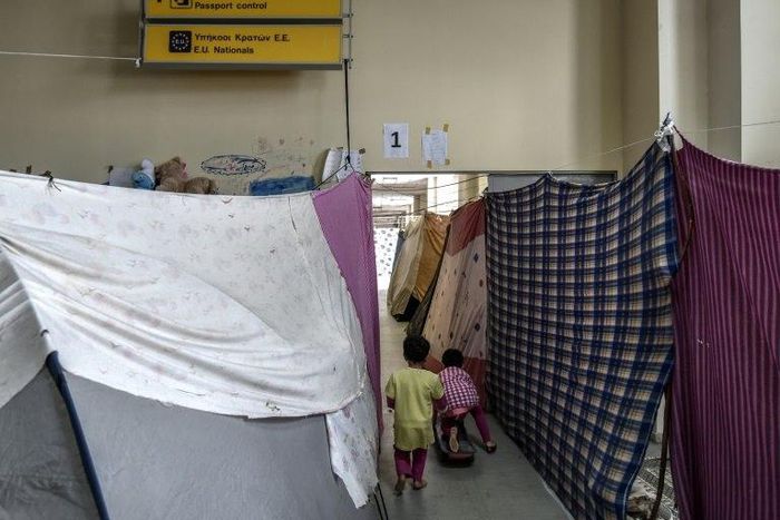 Children play in a corridor at the former Hellinikon airport turned into a refugee camp, near Athens, on March 30, 2017