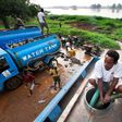 Truck drivers collect water directly from the Nile river to distribute to residents in Juba, South Sudan