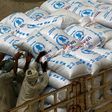 Sudanese workers offload US aid destined for South Sudan from the World Food Programme (WFP) at Port Sudan