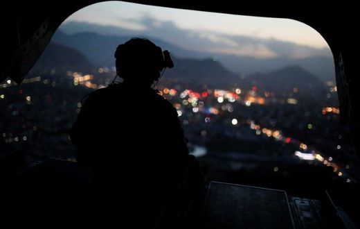 A US Army serviceman sits at the tailgate of an helicopter. The Afghan Taliban announce the start of their "spring offensive", saying they would target foreign forces in their country.