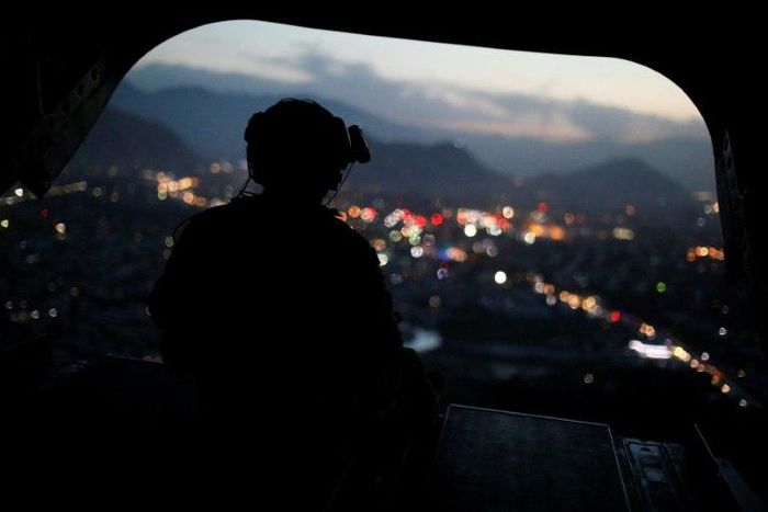 A US Army serviceman sits at the tailgate of an helicopter. The Afghan Taliban announce the start of their "spring offensive", saying they would target foreign forces in their country.