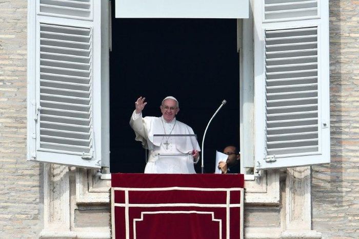 Pope Francis waves to pilgrims gathered in St. Peter's square during his Sunday Angelus prayer on February 12, 2017 at the Vatican