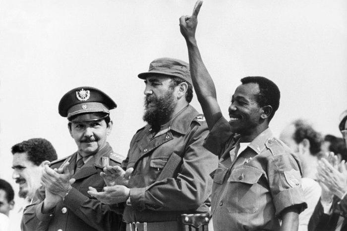 Then Ethiopian President Lieutenant Colonel Mengistu Haile Mariam (R) makes V sign alongside Fidel Castro (C) and Raul Castro (L) during an official visit to Havana, Cuba, on April 15, 1975