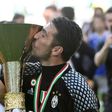 Juventus' goalkeeper from Italy Gianluigi Buffon kisses the trophy after winning the Italian Serie A football match Juventus vs Crotone and the "Scudetto" at the Juventus Stadium in Turin on May 21, 2017