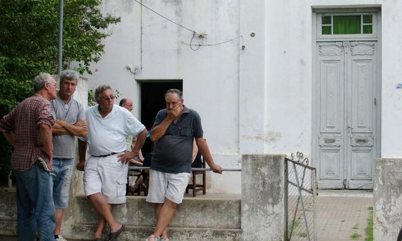 Friends and neighbors console Emiliano Sala's father Horacio Sala (2-R) in front of his house in Progreso, Santa Fe province, Argentina