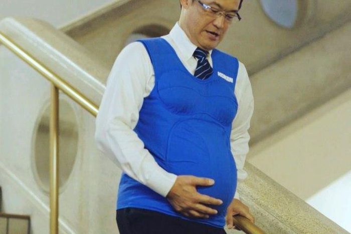 Japanese politician Shunji Kono wears a pregnancy vest in a video filmed by the Kyushu-Yamaguchi Work Life Balance Promotion Campaign